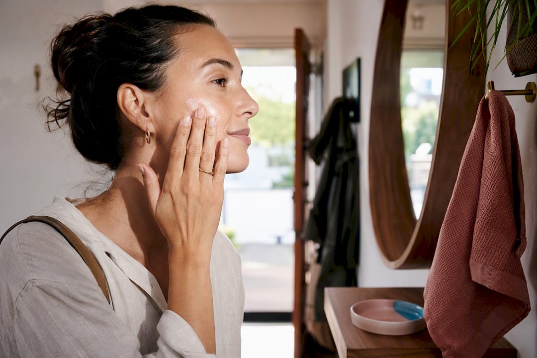 Mother applying sunscreen during morning routine