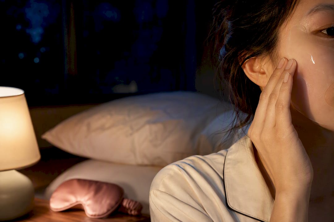 Person applying translucent overnight hydrogel mask